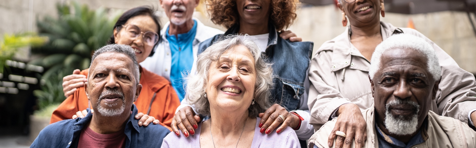 A group of older people, smiling at the camera