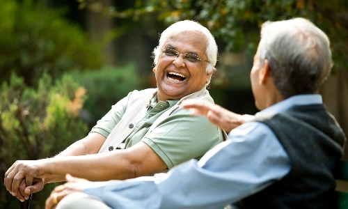 An older man laughing with his friend